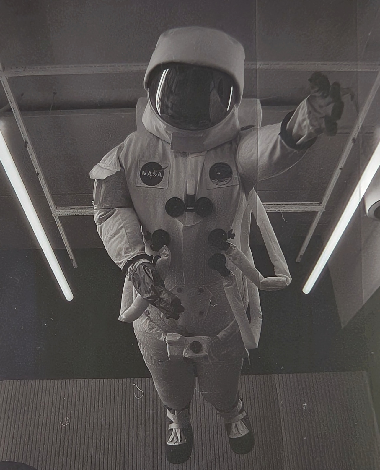 An astronaut spacesuit hanging from the ceiling